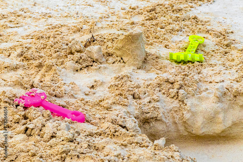 Beach toys colorful bucket shovel on white sand Caribbean Mexico.