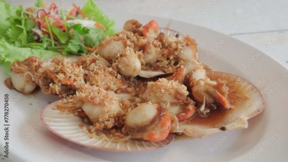 Man eating scallops in street cafe close-up. Man eating scallops in street cafe close-up.