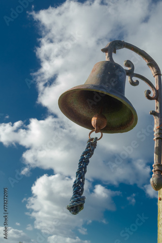 Bell against cloudy sky