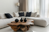 Modern Corner Sofa with Natural Wood Coffee Table. A serene living room setup with a plush white corner sofa and a striking natural wood table