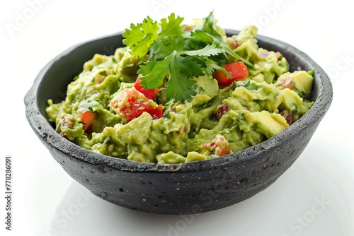 A delicious bowl of guacamole topped with fresh cilantro leaves and diced tomatoes.