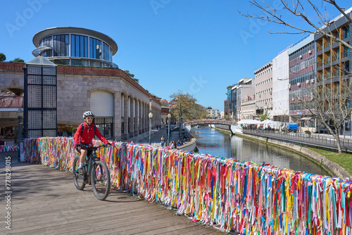 nice senior woman cycling with her electric mountain bike in the picturesque city of Aveiro, Portugal