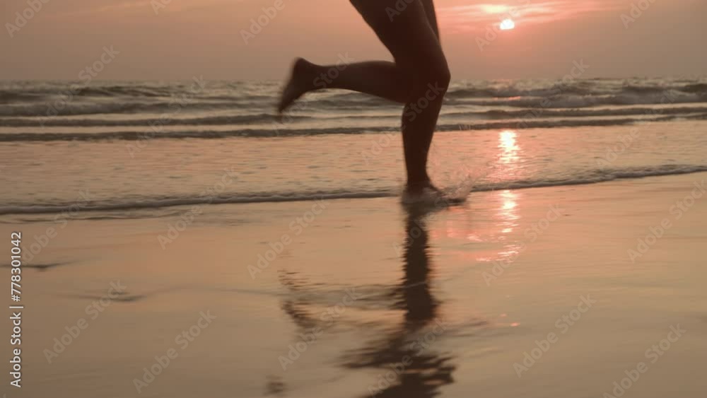 Happy woman feet running playfully barefoot on sandy beach splashing on water of sea or ocean at sunset. Vacation good mood concept. Happy woman feet running playfully barefoot on sandy beach splashing on water of sea or ocean at sunset. Vacation good mood concept.