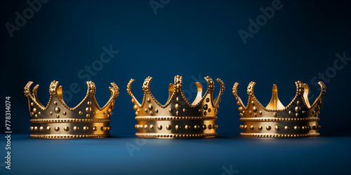  three gold crowns on blue background, Medieval crown of royalty. 
