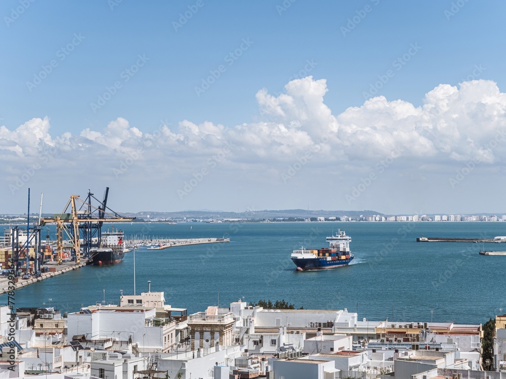 A large container cargo transport ship arriving to the port harbor of Cadiz, Andalusia, Spain