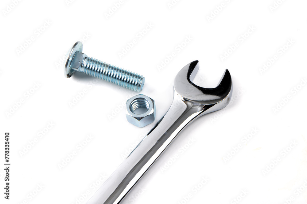 An open end wrench with a bright steel or stainless steel hex carriage bolt and hex nuts isolated on white An open end wrench with a bright steel or stainless steel hex carriage bolt and hex nuts isolated on white