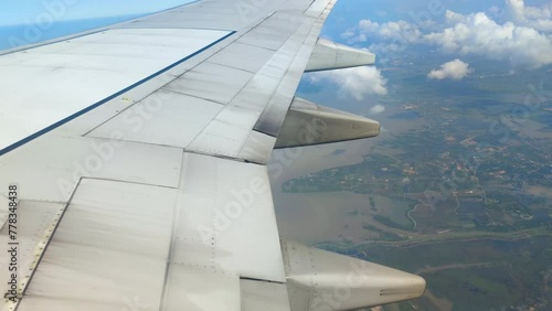 The view from the airplane window. Flying above the blue sky with moving clouds. Traveling on airplane at clear weather day.