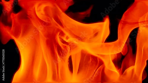 Flames of fire on a black background. Abstract fiery texture. Realistic fire flames burn movement frame. Texture of fire for Design.