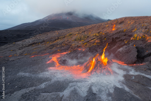 Smoke billows from a fiery mountain peak in a volcanic landscape