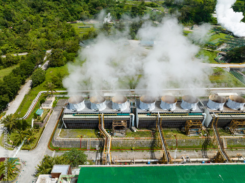 Geothermal power plant with smoking pipes and steam. Renewable energy production at a power station. Negros, Philippines.
