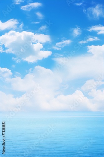 Blue sky and ocean with white clouds, perfect for a relaxing day.