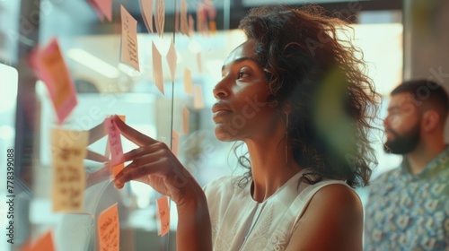 Woman Brainstorming with Sticky Notes photo