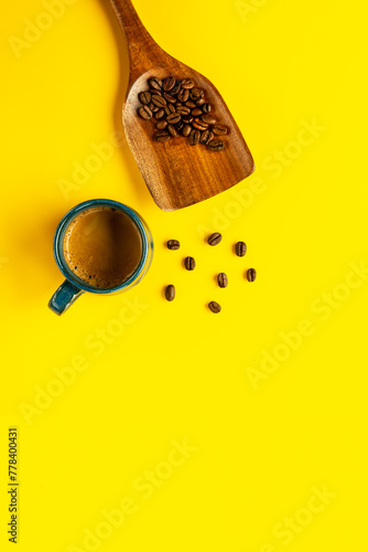 Flat lay composition with coffe cup with espresso coffee  and wooden spoon with beans.