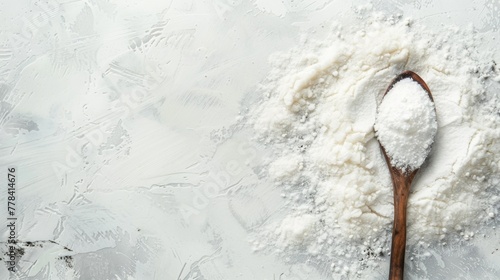 A Spoon Full of Powdered Sugar on a White Surface photo