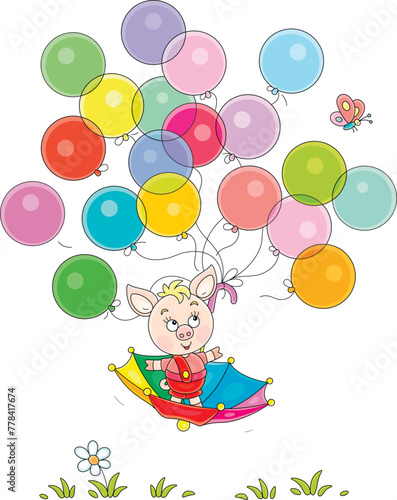 Funny cartoony little piglet flying in an umbrella with colorful toy balloons and merry butterfly over a green summer lawn, vector cartoon illustration on a white background