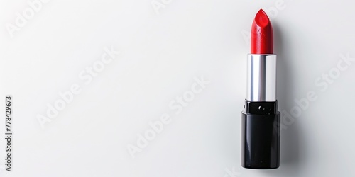 a red lipstick against white background with copy space  overhead view