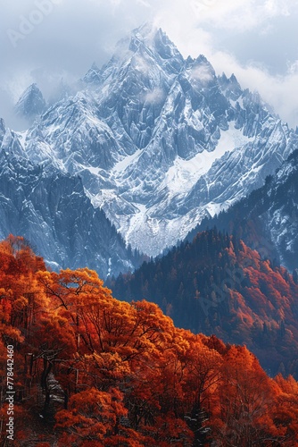 a snowy mountain range with trees and orange leaves