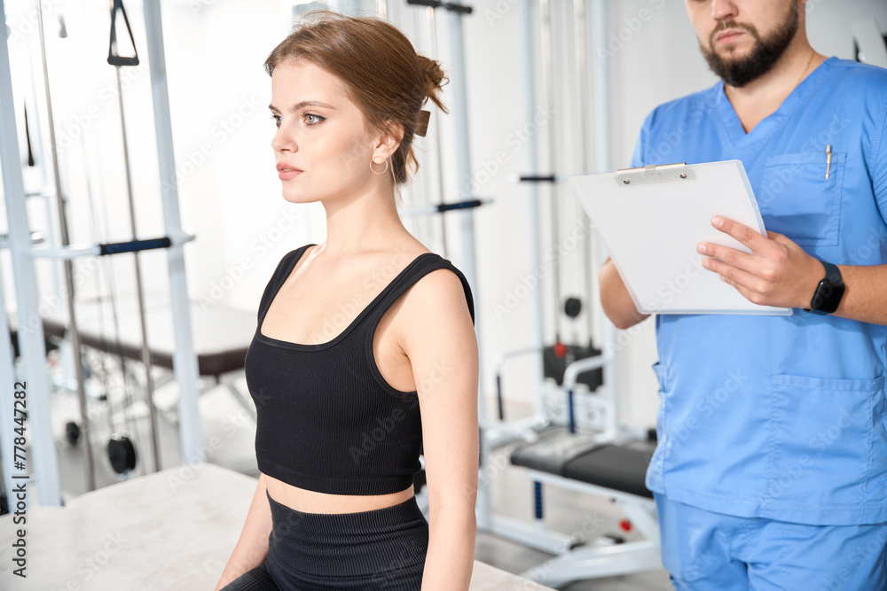 Fototapeta premium Kinesiologist interviews a young woman