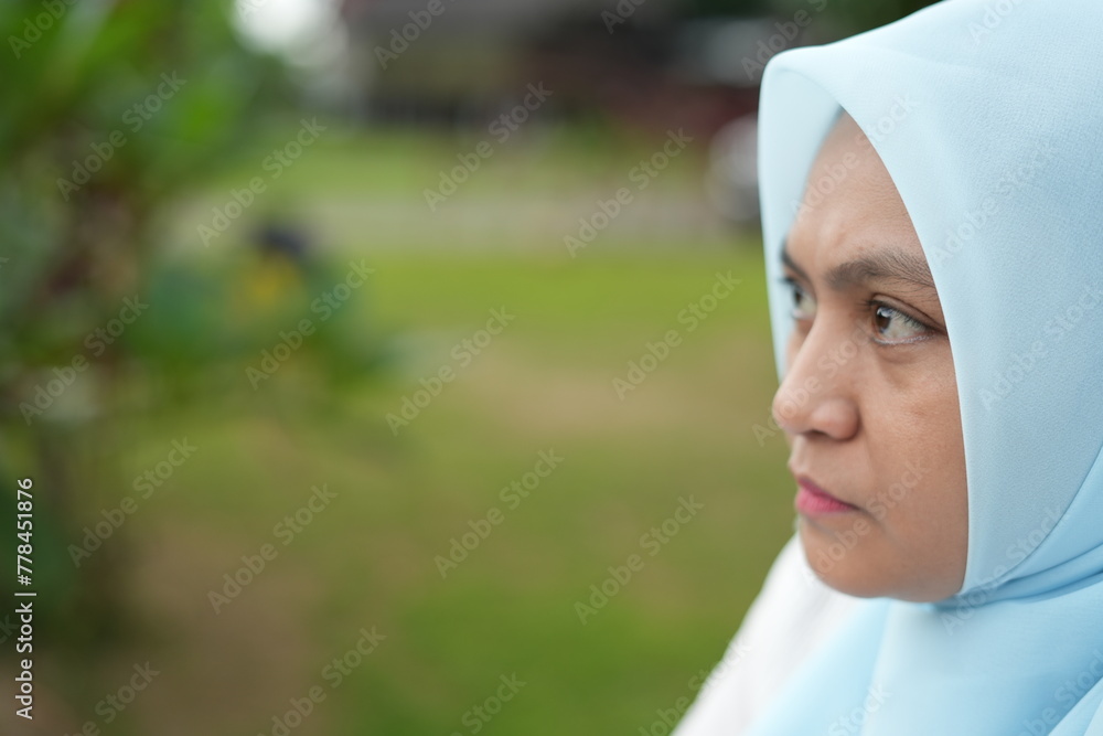 Portrait of the expression of an Asian woman wearing a hijab while in the park Portrait of the expression of an Asian woman wearing a hijab while in the park