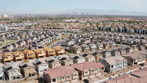 Aerial view of Las Vegas residential homes with solar panels and city skyline