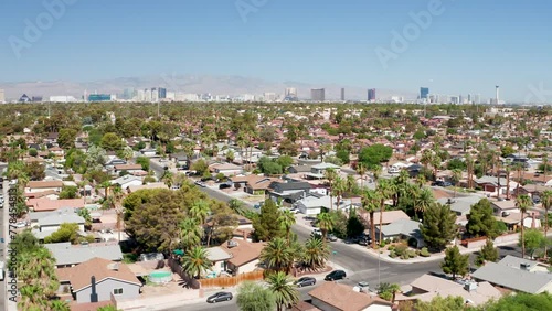 Aerial moving shot of Las Vegas suburb with strip city skyline in background