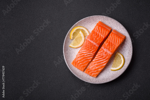 Fresh raw salmon steak with spices and herbs prepared for grilled baking