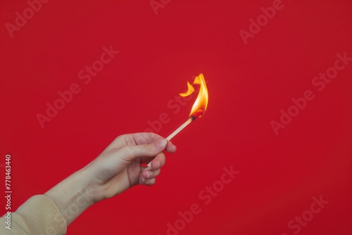 Hand Holding Matchstick. Isolated on White Background with Burning Flames and Fire on Thumb