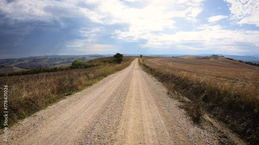 Via Francigena - gravel road in the countryside near Torrenieri, Montalcino, Province of Siena, Tuscany, Italy Via Francigena - gravel road in the countryside near Torrenieri, Montalcino, Province of Siena, Tuscany, Italy