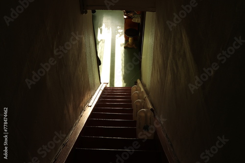Stairs down in old house and contrasting sunlight. Photo was taken 21 March 2024 year, msk time.