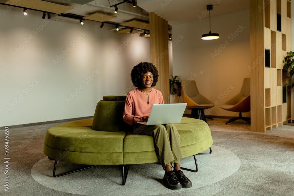 Radiant African American entrepreneur innovating at her modern workspace during a peaceful morning Radiant African American entrepreneur innovating at her modern workspace during a peaceful morning