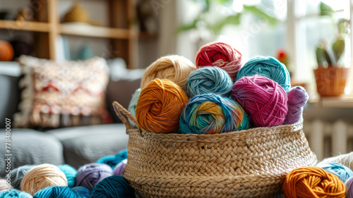 Basket of colorful yarn balls on a couch.