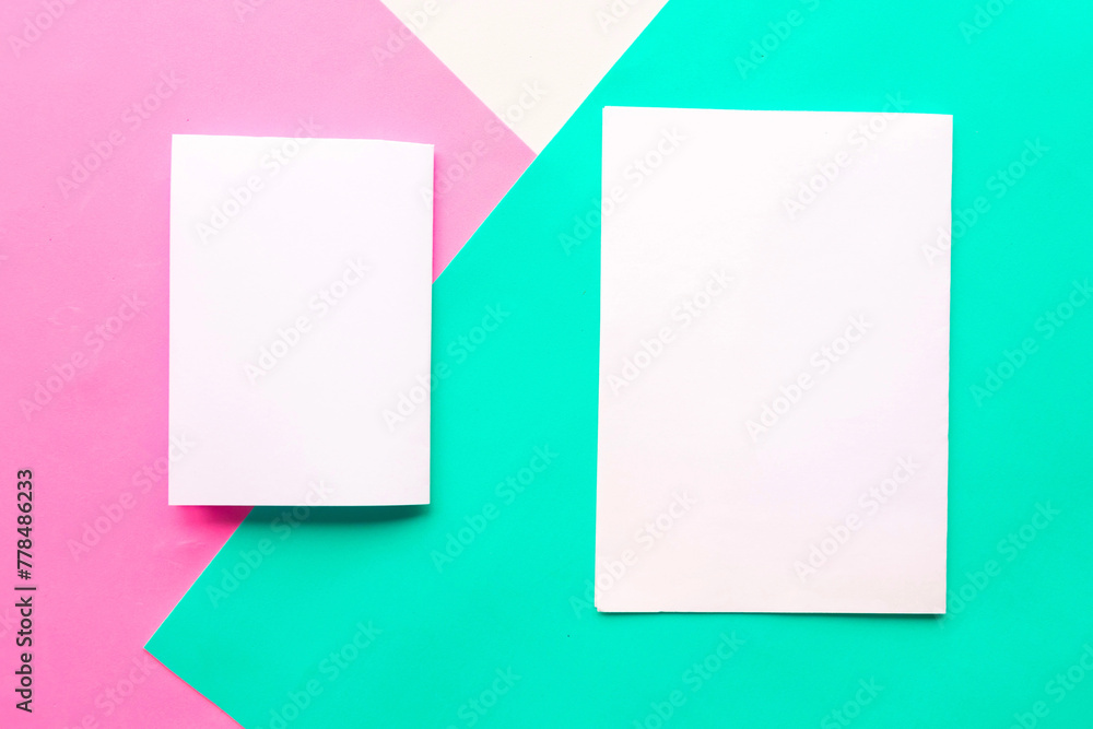 Two white mockup blanks on geometric green, pink and white background. Copy space for the text. Minimal concept