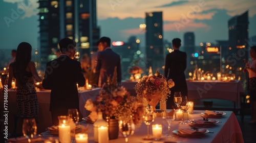 A romantic outdoor roof top dining setting as the sun sets, with guests enjoying the ambiance of warm candlelight and city views. Birthday, corporate party celebration. © netrun78