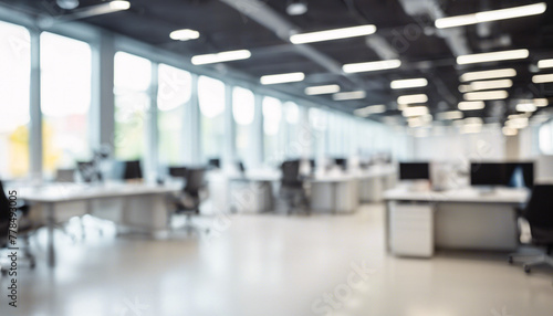 Blurred open space office interior with desks and panoramic windows