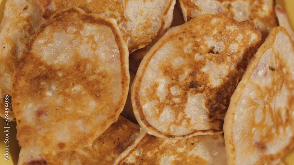 Rotating plate with strawberry fritters pancakes. Close up. Top view. Rotating plate with strawberry fritters pancakes. Close up. Top view.