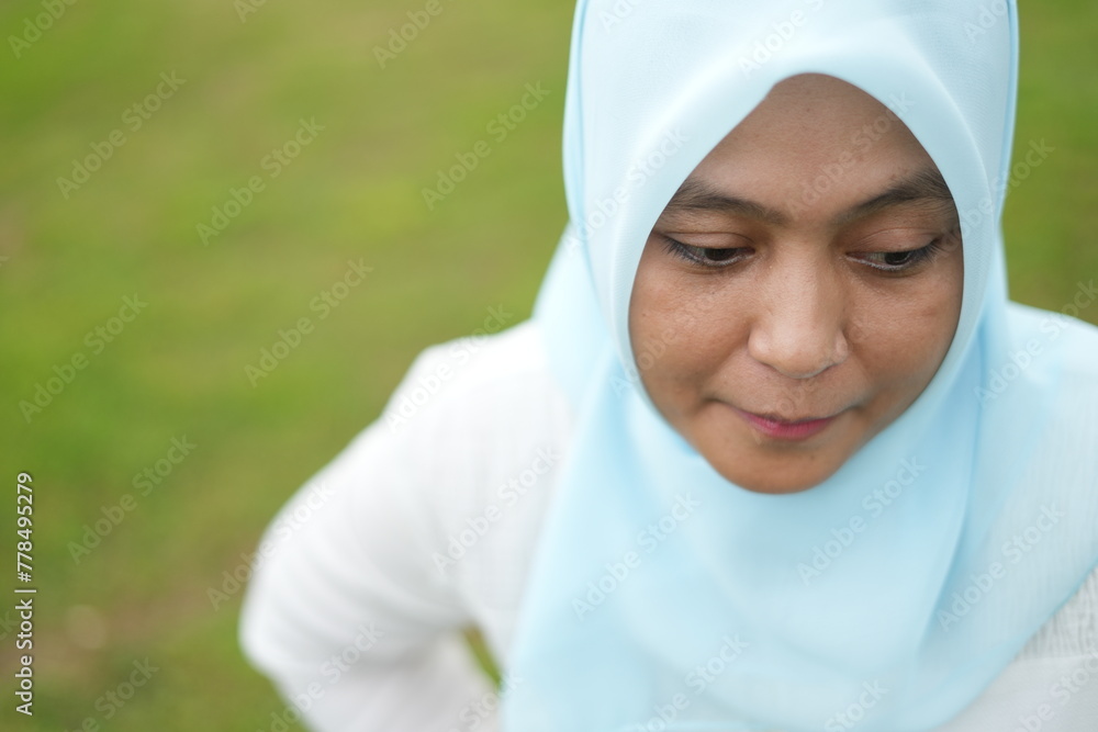 Portrait of the expression of an Asian woman wearing a hijab while in the park Portrait of the expression of an Asian woman wearing a hijab while in the park