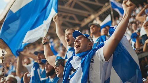 Finnish football fans with flags cheering in stadium photo