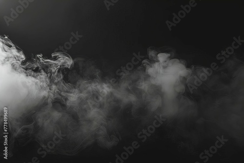 Misty black smoke or fog on dark background, eerie atmospheric overlay effect