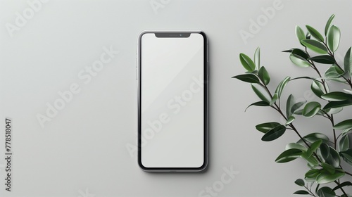 Smartphone mockup with blank screen on gray background with green plant