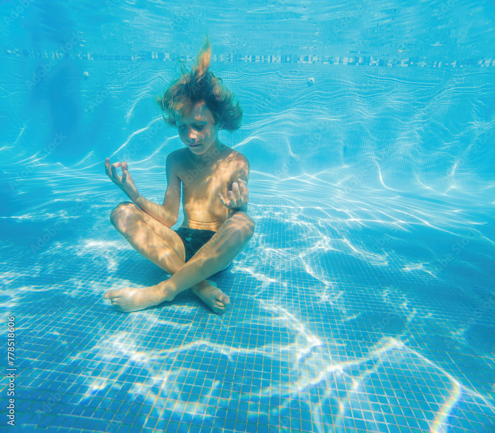 In serene underwater stillness, a boy finds tranquility in lotus position, embracing a moment of meditation in the crystal-clear depths of a pool