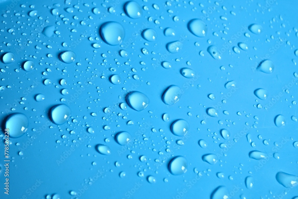 Natural blue water drops on a blue background