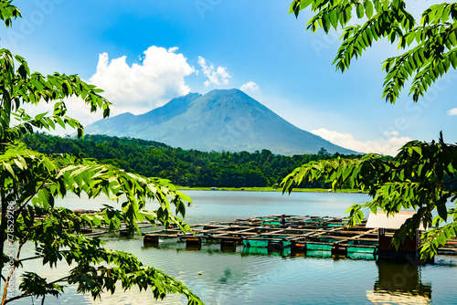 a majestic volcano with a calm lake in front of it. photo