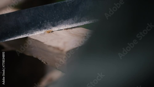 Carpenter uses drawknife to peel wood carefully, very satisfying photo