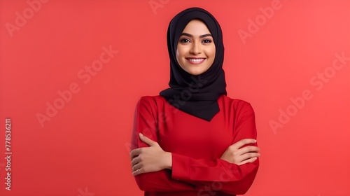 Close-up portrait of attractive arabic woman wearing scarf and crossing hand on red background. Business concept