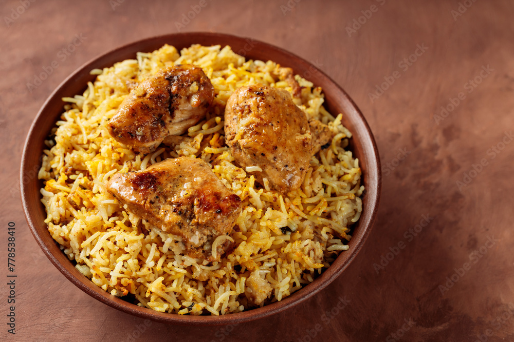 Indian Traditional Chicken Biryani Rice in Bowl on Brown Background, Copy Space Indian Traditional Chicken Biryani Rice in Bowl on Brown Background, Copy Space
