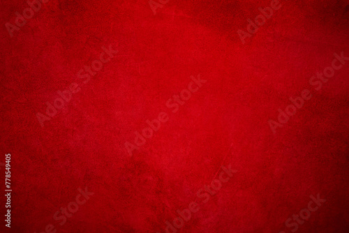 Suede background with small scratches, light red in the center and dark around the edges. © Lesia