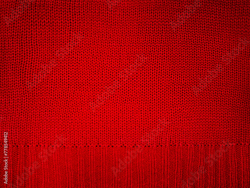 Knitted fabric red macro photo. Element of part of knitted clothes, sweater. © Lesia