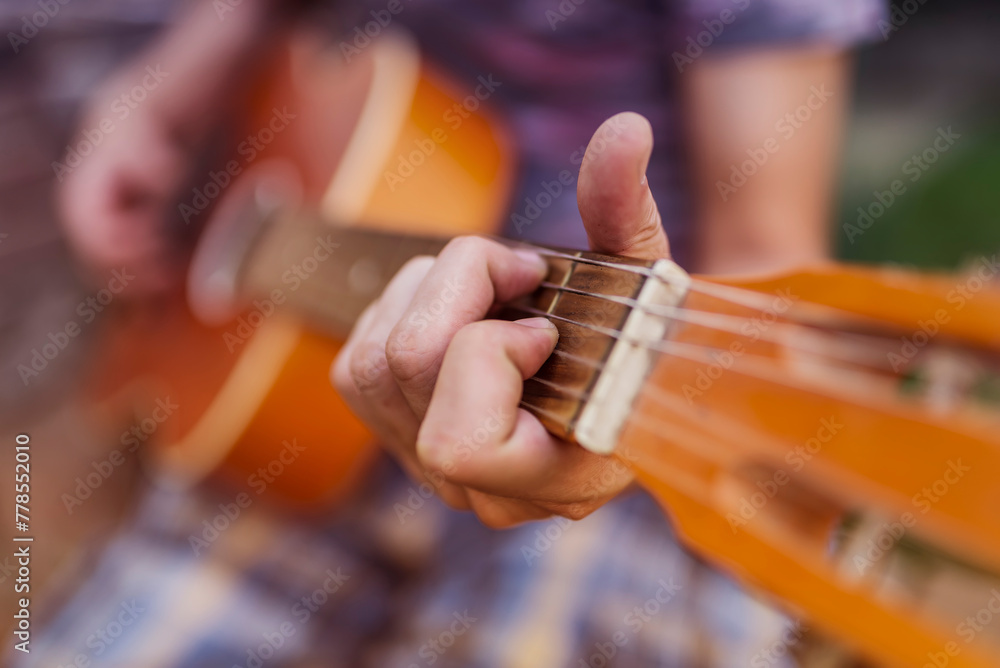Close Up Of Guitarist Hand Playing Guitar. Musical And Instrument Concept. Outdoors And Leisure Theme.