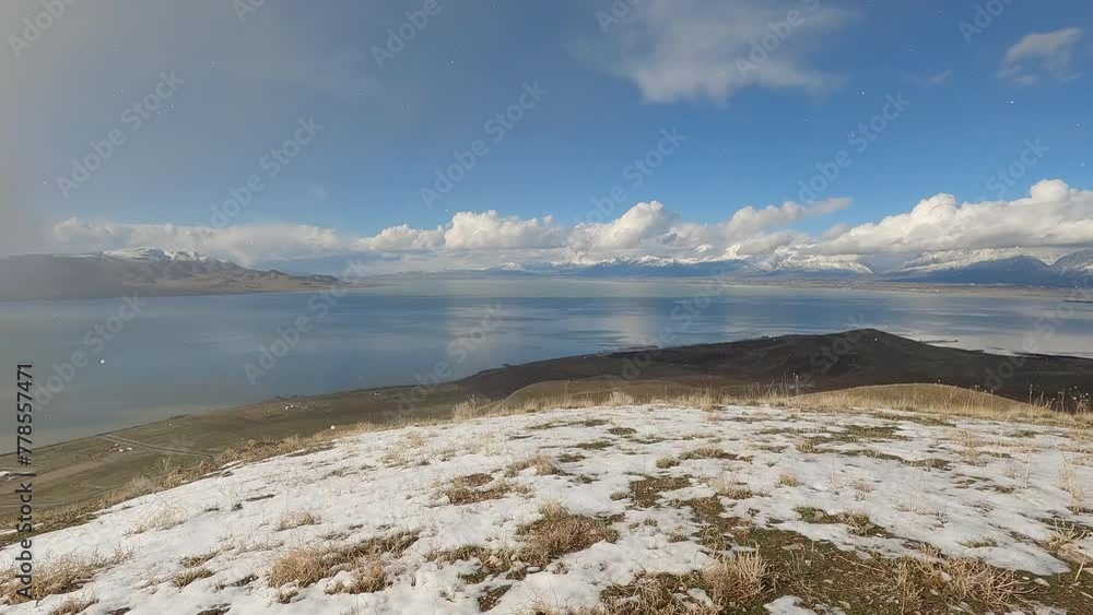 Panning view during light snow storm on sunny day from West Mountain during Spring in Utah as patchy weather moves over Utah Lake. Panning view during light snow storm on sunny day from West Mountain during Spring in Utah as patchy weather moves over Utah Lake.