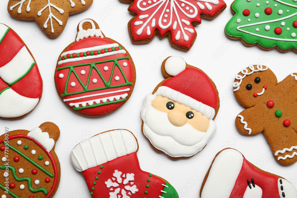 Different tasty Christmas cookies on white background, flat lay